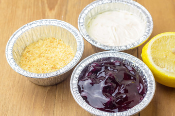 blue berry cheese pie tart and cut lemon on wood background