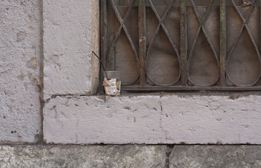 a plastic cup left on a windowsill in the street
