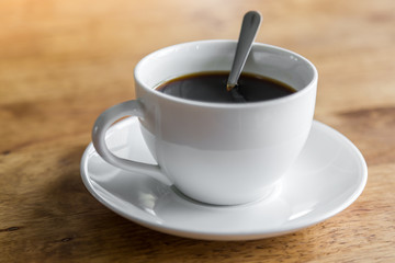 Coffee in white cup on wood table