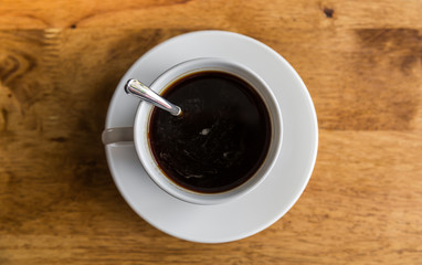 Coffee in white cup on wood table