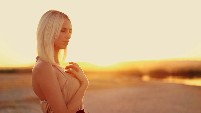 young sexy girl in the sunset in the desert sand