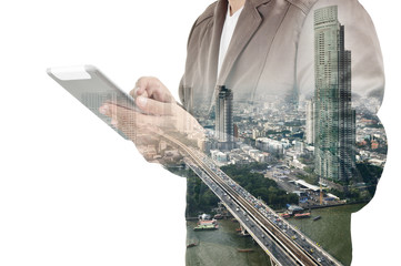 Double exposure of city and Businessman use Tablet device