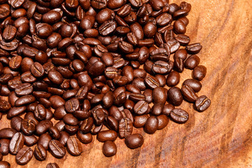 Coffee beans on the wooden background.