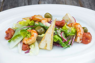 Prawns salad on a wooden background