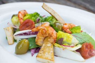 Prawns salad on a wooden background
