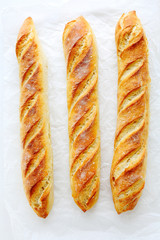fresh baguette on white paper