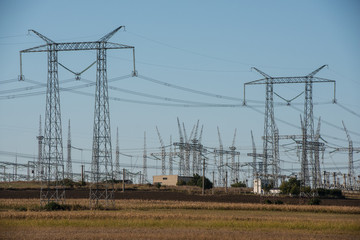 Multitude of high-voltage power line on a field