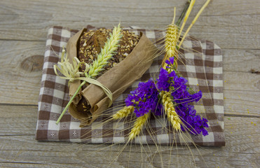bread wrapped in paper with spikelets of wheat