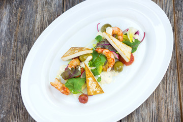 Prawns salad on a wooden background