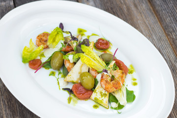 Prawns salad on a wooden background
