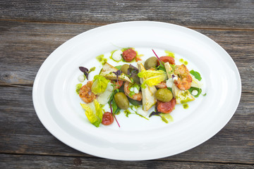 Prawns salad on a wooden background