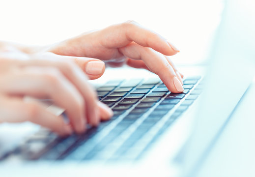 Female hands or woman office worker typing on the keyboard