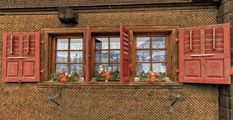 Fototapeta na wymiar Chalet with shutters red