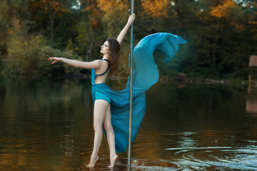 Girl in the woods a lake dancing dance.