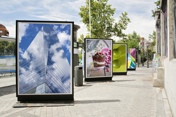 billboards with photographs at city street - obrazy, fototapety, plakaty