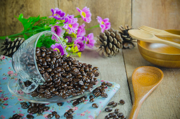 coffee beans with  cup on wood table