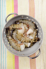 raw king prawns in a colander