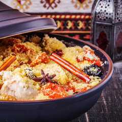 Traditional moroccan tajine of chicken with dried fruits and spi