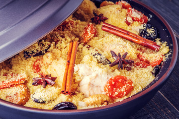 Traditional moroccan tajine of chicken with dried fruits and spi