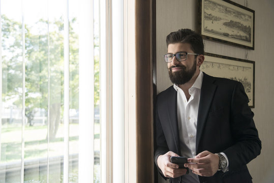 young manager in his office with smartphone