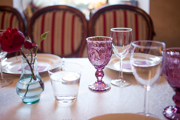interior of the restaurant,  large table laid for  Banquet, decorated in Burgundy tones
