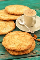 Fresh homemade coffee espresso with froth, silver spoon, almond