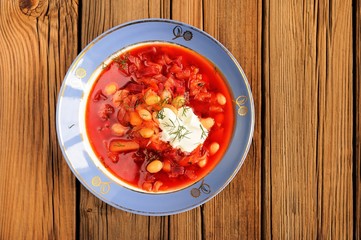 Portion of homemade Russian red beet soup borsch with bean, cabb