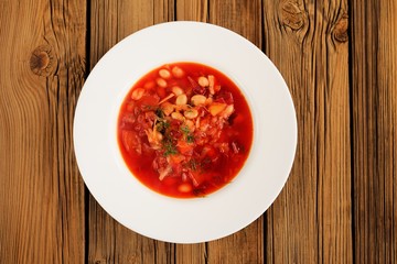 Portion of homemade Russian red beet soup borsch with bean, cabb