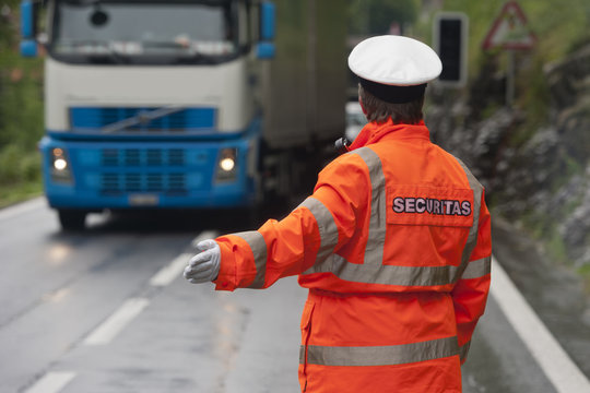 Police in hi-visibility jackets, securitas traffic control on the road.