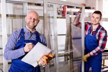 Two workers inspecting windows