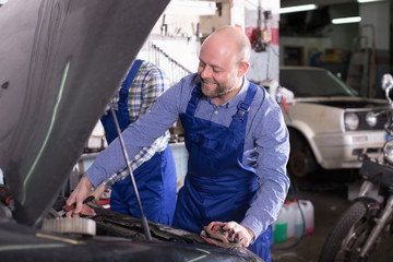 Fototapeta premium Professional mechanics repairing car