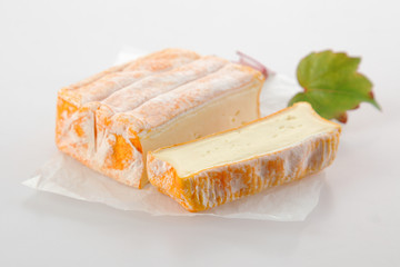 Brick of aromatic soft French cheese