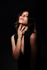 Fototapeta premium Stylish portrait of model on a dark background.