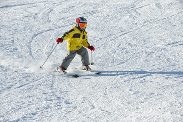 Fototapeta na wymiar The boy on skis in mountains