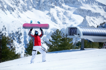 Happy snowboarder with snowboard