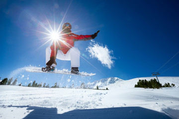 Snowboarder jumping in air