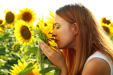 Beautiful girl in the sunflowers field