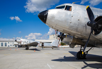 two old aircraft 40s standing in the parking lot at the airport