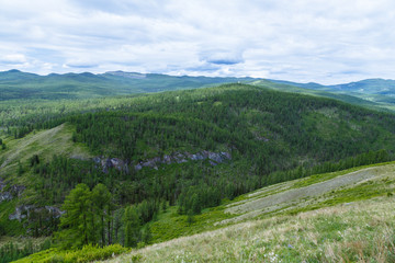 Fototapeta na wymiar clouds over the mountain range of Altai summer sunny day