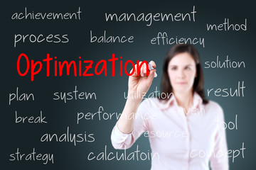 Young business woman writing optimization concept. Blue background. 