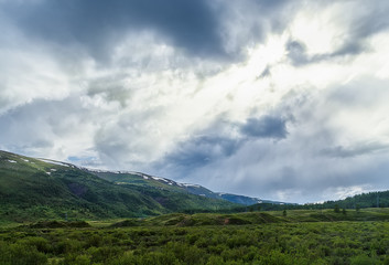 Fototapeta na wymiar clouds over the mountain range of Altai summer sunny day