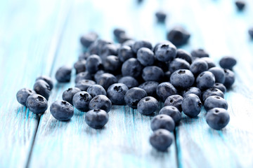 Tasty blueberries on a blue wooden table