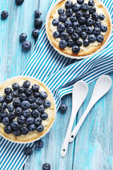 Homemade blueberry tart on blue wooden table