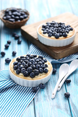 Homemade blueberry tart on blue wooden table