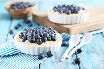 Homemade blueberry tart on blue wooden table