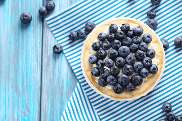 Homemade blueberry tart on blue wooden table