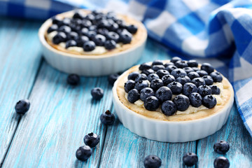 Homemade blueberry tart on blue wooden table