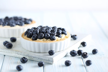 Blueberry tart on blue wooden table