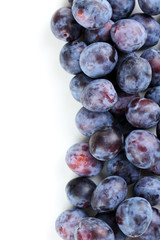 Fresh plums on a white background