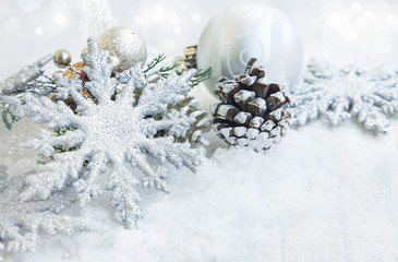 Fototapeta na wymiar Festive Silver Christmas Snowflakes Ornaments and Snow